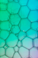 Fototapeta premium Extreme closeup of soap bubble patterns creating an art image with shadow effect caused by lighting and colour.