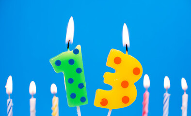 Burning birthday cake candle number 13. Happy Birthday background anniversary celebration concept