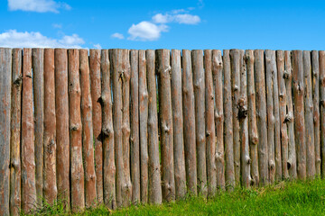 Fototapeta premium Log wooden fence. The texture of the old wooden fence. Wooden vintage background.