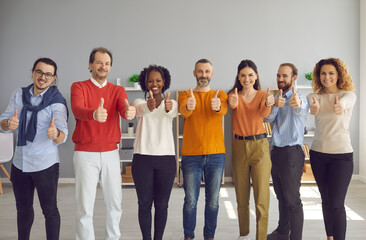 Diverse multiracial different age group of smiling people looking at camera show thumbs up and satisfaction emotion happy expression make approval gesture stand in row. Recommend, positive feedback
