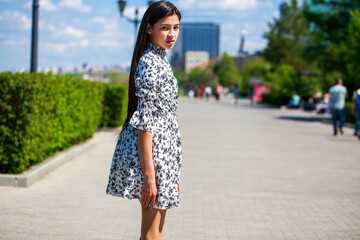 Fototapeta premium Portrait of a young beautiful girl in summer park