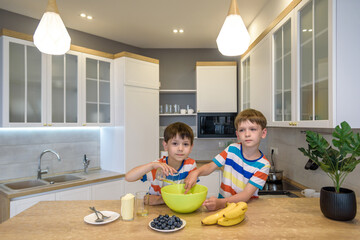 Fototapeta premium happy family funny kids are preparing the dough, bake cookies in the kitchen