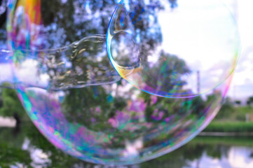 Big soap bubbles in the forest in summer copy space, background 