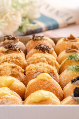 A bombolone or bomboloni is an Italian filled doughnut and is eaten as a snack food and dessert. This Bomboloni has many flavors like strawberry, chocolate, blueberry, etc.