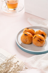 A bombolone or bomboloni is an Italian filled doughnut and is eaten as a snack food and dessert. This Bomboloni has many flavors like strawberry, chocolate, blueberry, etc.