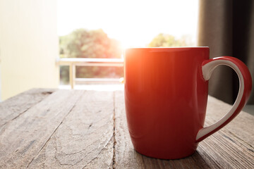 red coffee mug placed on wood