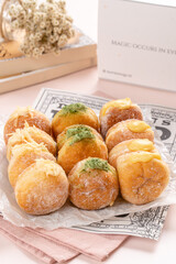 A bombolone or bomboloni is an Italian filled doughnut and is eaten as a snack food and dessert. This Bomboloni has many flavors like strawberry, chocolate, blueberry, etc.