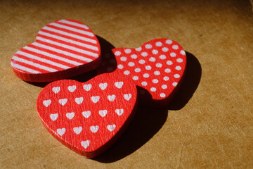 red wooden hearts on recycled paper, macro photography