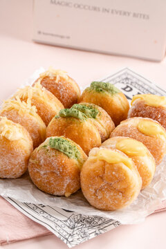 A bombolone or bomboloni is an Italian filled doughnut and is eaten as a snack food and dessert. This Bomboloni has many flavors like strawberry, chocolate, blueberry, etc.