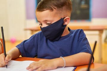 Junge mit Schutzmaske wegen Covid-19 und Coronavirus