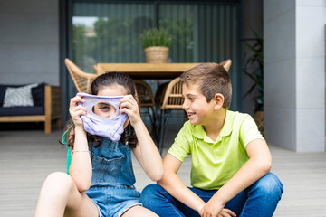 Two kids playing with a slime at home