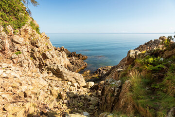Fototapeta na wymiar Scenic view of rocks by sea against sky
