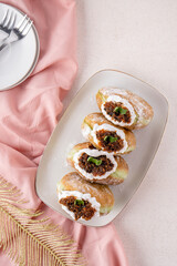 A bombolone or bomboloni is an Italian filled doughnut and is eaten as a snack food and dessert. This Bomboloni has many flavors like strawberry, chocolate, blueberry, etc.