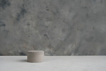 Empty pedestal or product display concrete podium with dry minimalistic flowers and nature leaves on green background. Copy space.