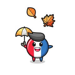 cartoon of the cute france flag badge holding an umbrella in autumn