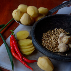 The photo is a photo of ingredients in the form of chilies and potatoes