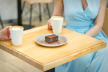 Two women with sitting at the table in cafe