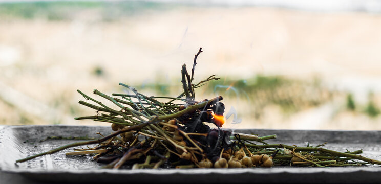 Burning Harmala (also Known As Yuzarlik) On A Sliver Plate.