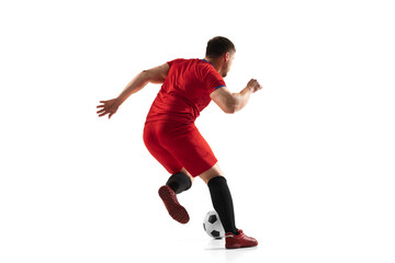 Powerful, flying above the field. Young football, soccer player in action, motion isolated on white background .