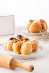 A bombolone or bomboloni is an Italian filled doughnut and is eaten as a snack food and dessert. This Bomboloni has many flavors like strawberry, chocolate, blueberry, etc.