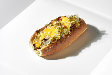 Classic cheese steak with pork, pickled cucumbers, onions, cheddar and mozzarella. White background. Hard light