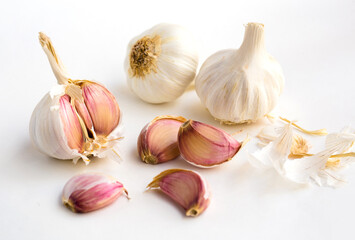 garlic heads and cloves on white background