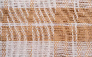 white and beige material made of natural linen cotton striped and checkered fabric towel macro view