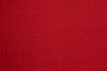Closeup macro of red fabric textile material as texture pattern background or backdrop