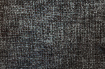 Fototapeta na wymiar retro sewing tools: old scissors, bobbins of thread on gray fabric. Tailor's desk. manufacture of textiles or fine fabrics.
