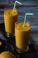Refreshing mango shake drink in a glass with use of selective focus, an ideal for the summer season
