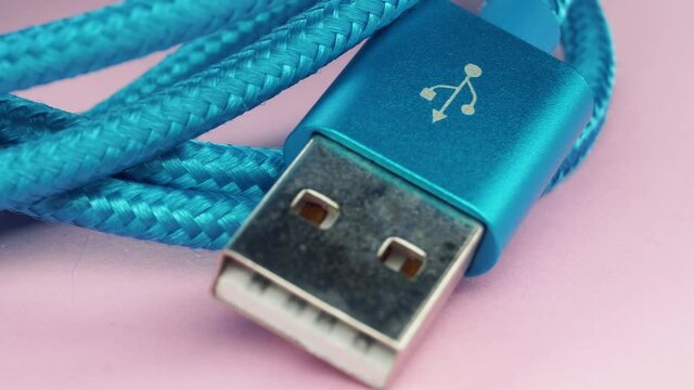 Usb type c cable panning on pink backround.