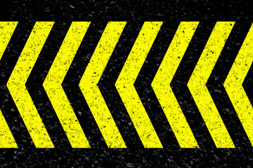 Fototapeta premium Chevrons jaunes sur asphalte 