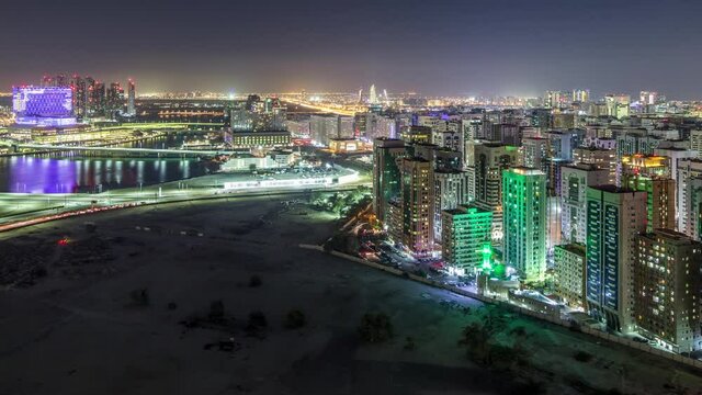 Aerial skyline of Abu Dhabi city centre from above day to night timelapse