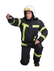 Full length portrait of firefighter in uniform and helmet on white background