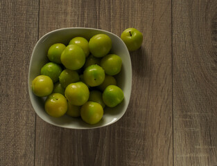green plum in a bowl