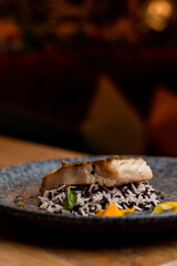 Gourmet roasted fish with wild rice, restaurant photo