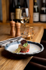 Seafood restaurant tartar with fresh raw fish and strawberry, modern fusion cuisine