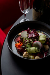 Top view of scandinavian beef steak salad, with mustard sauce, peas and cucumber, black flat background