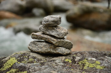 Stack rocks, pile rocks close up next to river in the mountains
