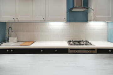 Fototapeta na wymiar Blurred elegant marble tabletop with modern kitchen in the home background.