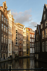 Fototapeta na wymiar Historical buildings of Amsterdam in the sunset light.