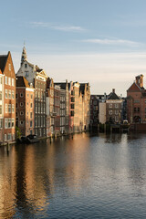 Naklejka premium Historical buildings of Amsterdam in the sunset light.
