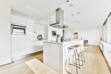 Modern galley kitchen with wooden cabinets and minimalist design in studio attic apartment with...