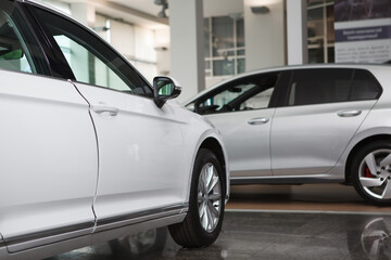 Cropped shot of unrecognizable new cars parked at automobile dealership salon