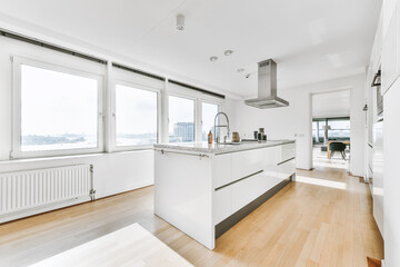 Modern galley kitchen with wooden cabinets and minimalist design in studio attic apartment with...