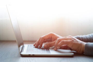 Close-up of man hands using and typing keyboard of laptop computer on office desk. Workspace, businessman working project creative idea for job online network. Business finance and technology concept.