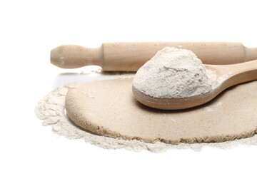 Dough and barley flour pile with wooden spoon and kitchen rolling pin isolated on white background