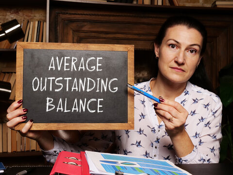 Financial concept meaning AVERAGE OUTSTANDING BALANCE with sign on the black board