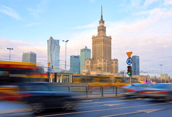 Fototapeta na wymiar High traffic near the Palace of Culture and Science in Warsaw, Poland. Long exposure shot of city life. Business center cityscape.