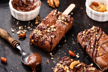 Chocolate ice cream popsicle with nut